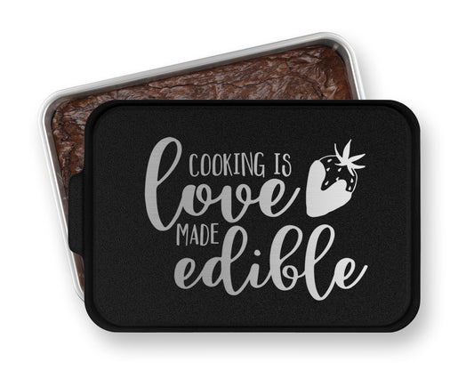 a cookie tin with a cookie in it that says cooking is love made edible