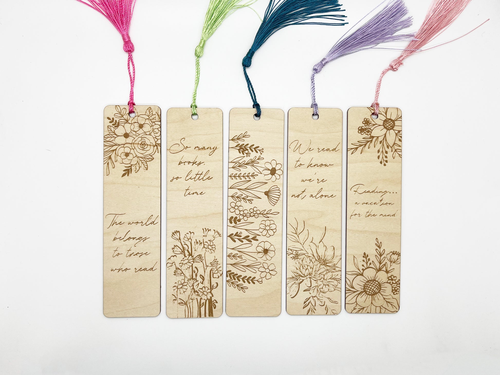 a set of four wooden bookmarks with flowers on them