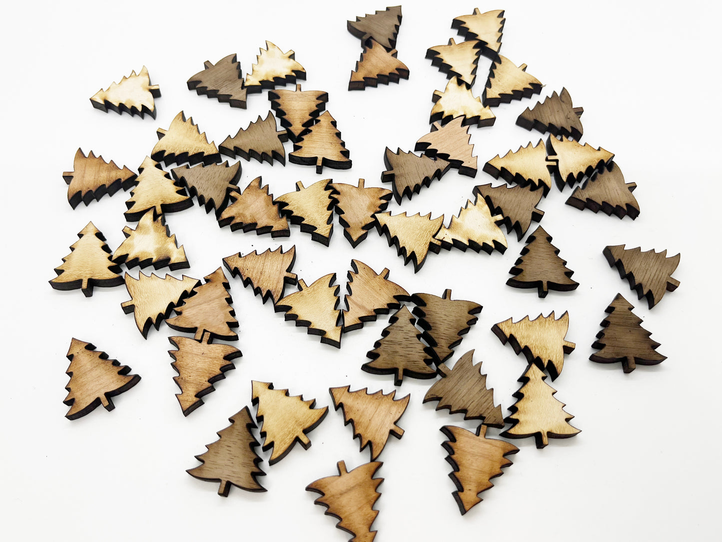 a pile of wooden christmas trees on a white surface