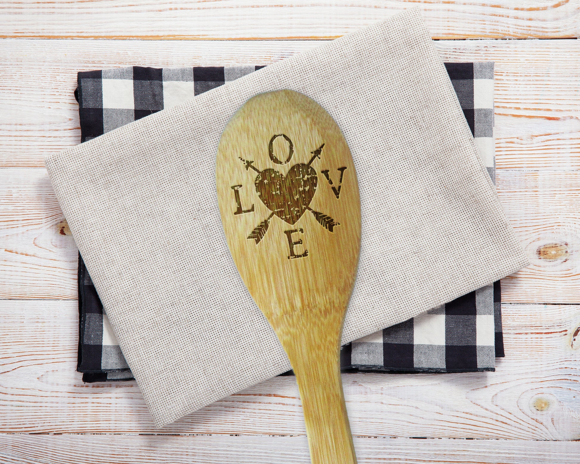 a wooden spoon sitting on top of a napkin