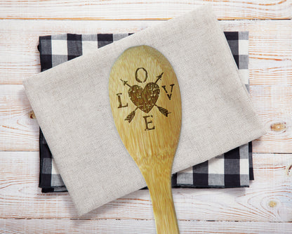 a wooden spoon sitting on top of a napkin