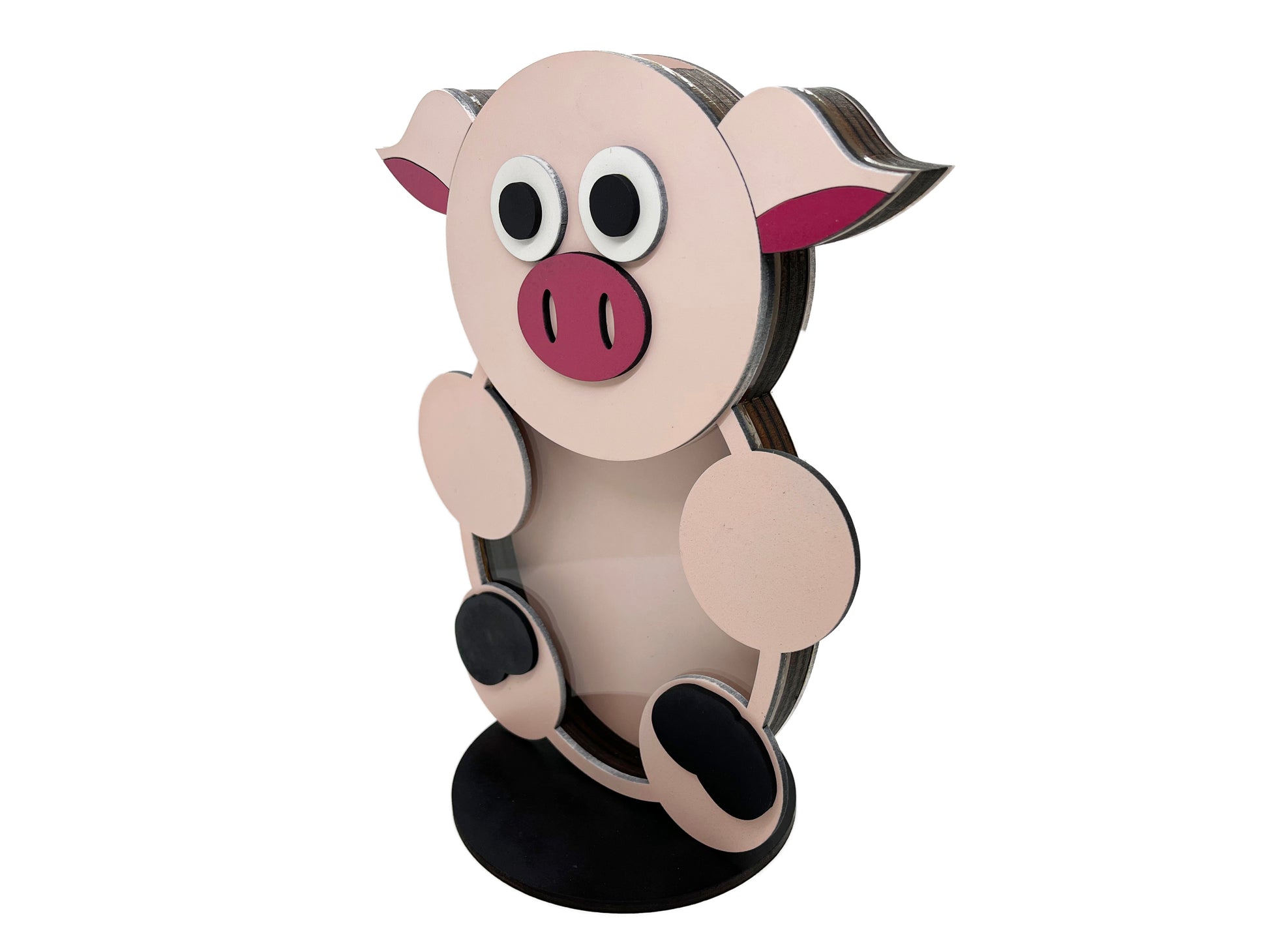 a paper cut out of a pig sitting on top of a table