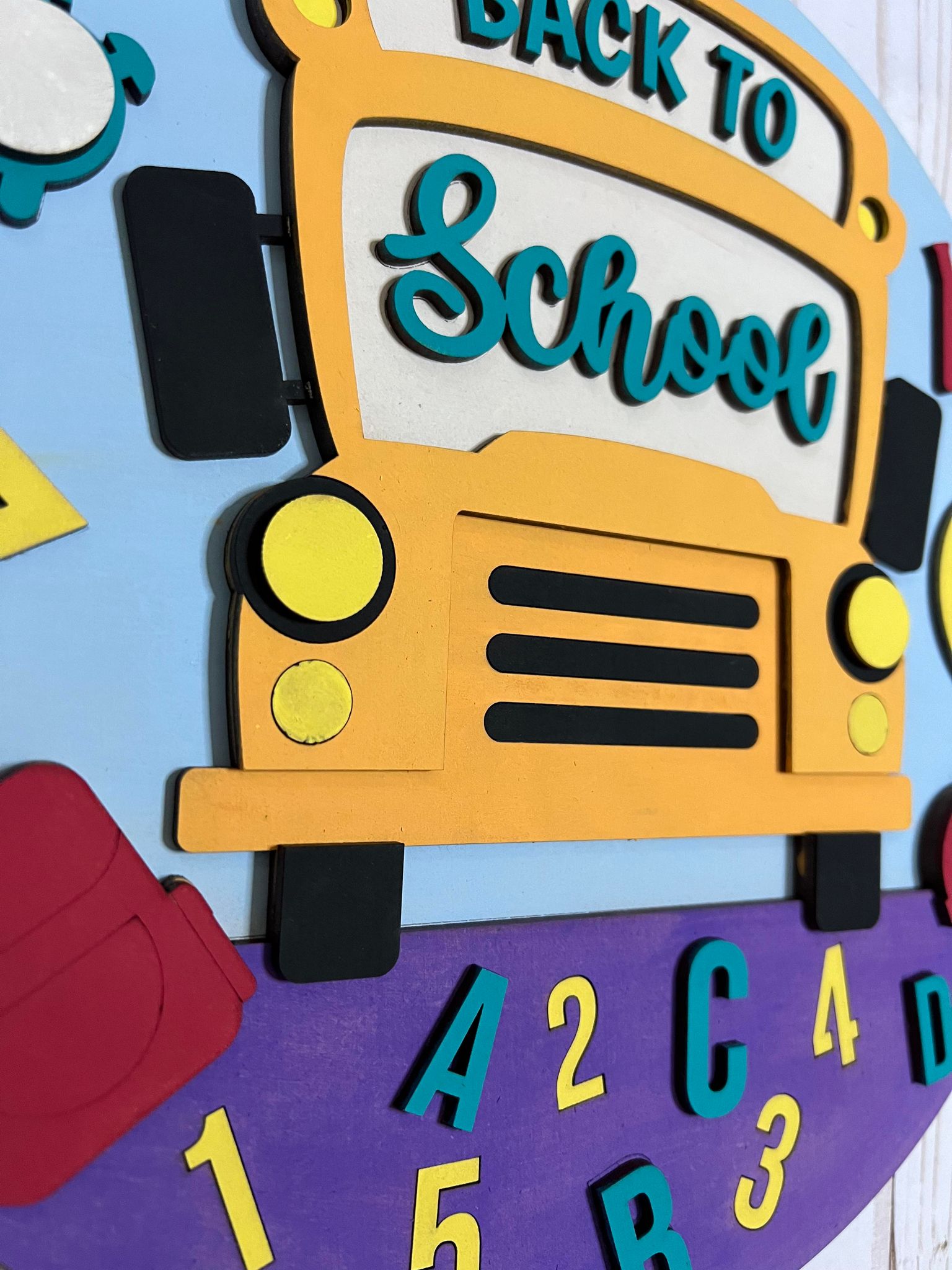 a clock with a yellow school bus on it