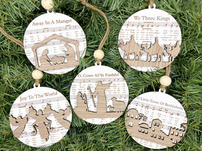 a group of wooden ornaments hanging from a christmas tree