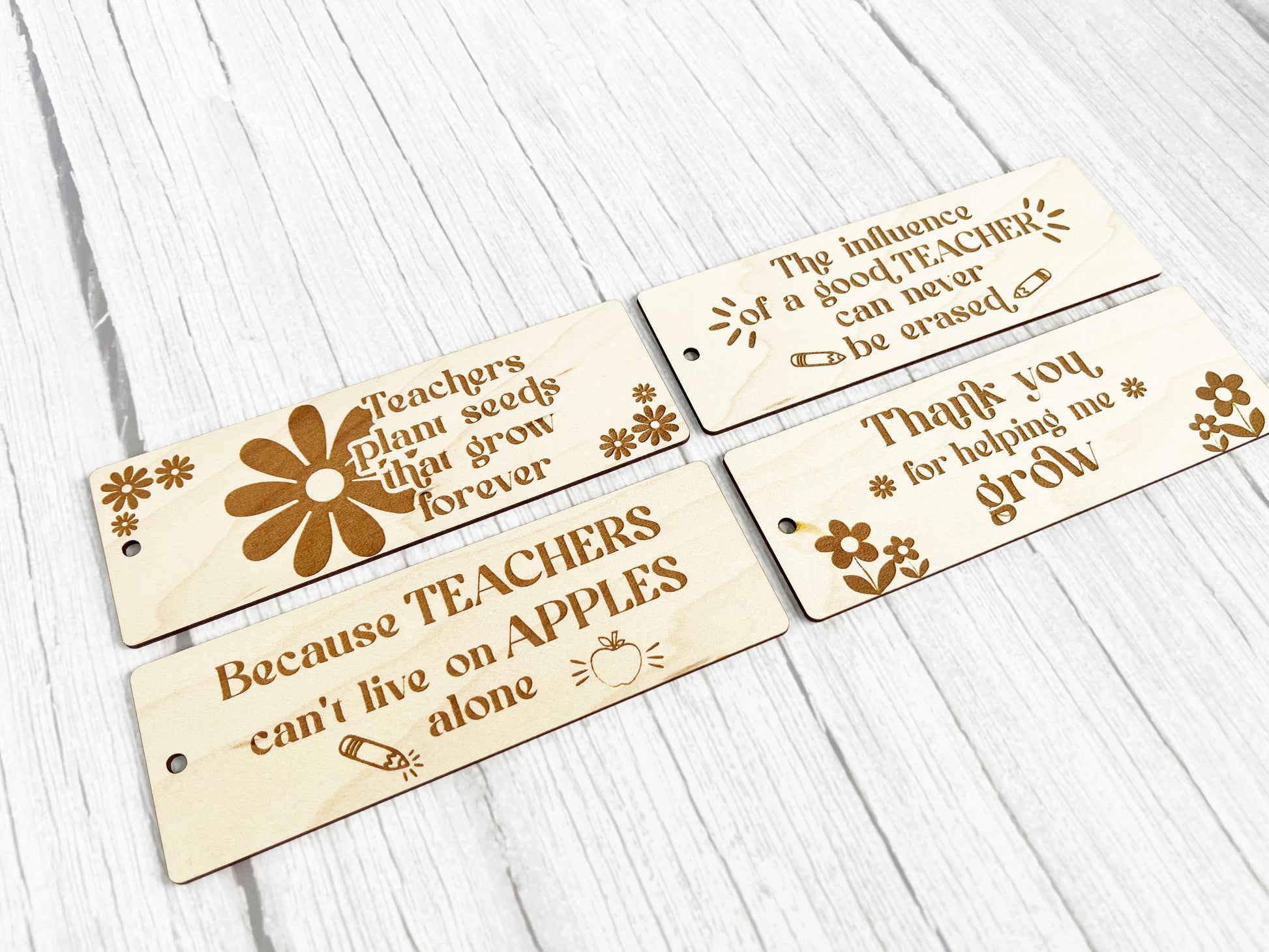 three wooden name tags with flowers on them