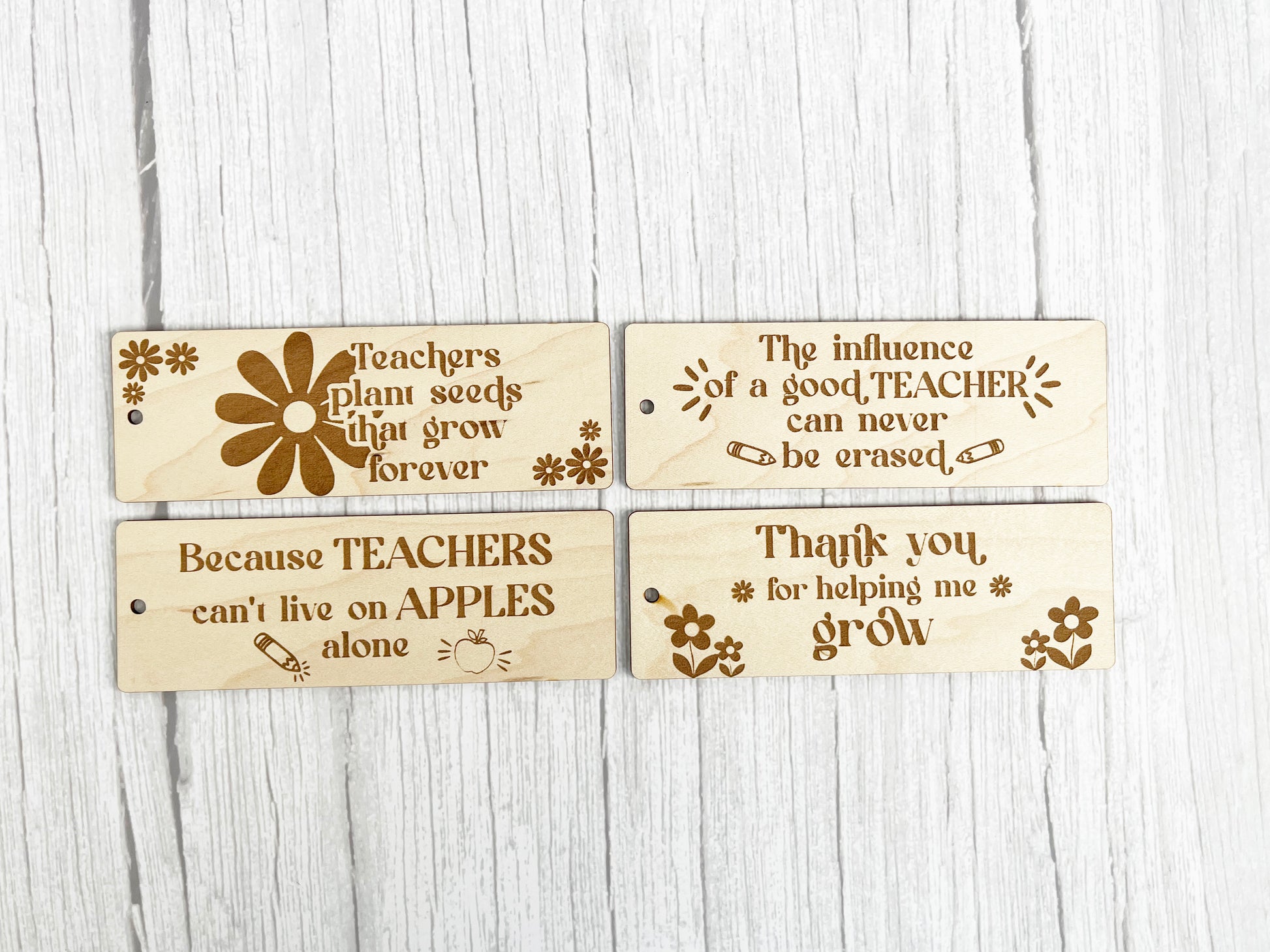 three wooden tags with words on them