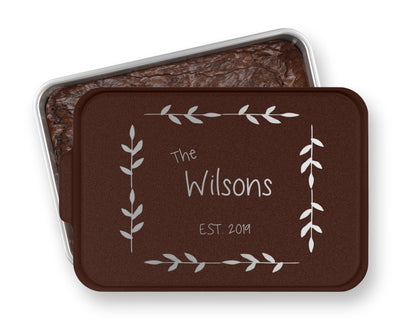 a chocolate cake in a tin with the words the wilsons on it