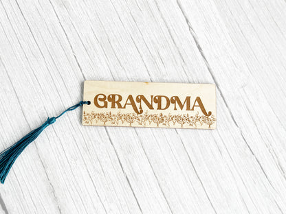 a wooden name tag with a tassel hanging from it