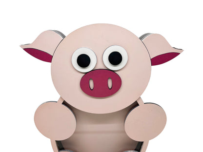 a pink pig with big eyes sitting down