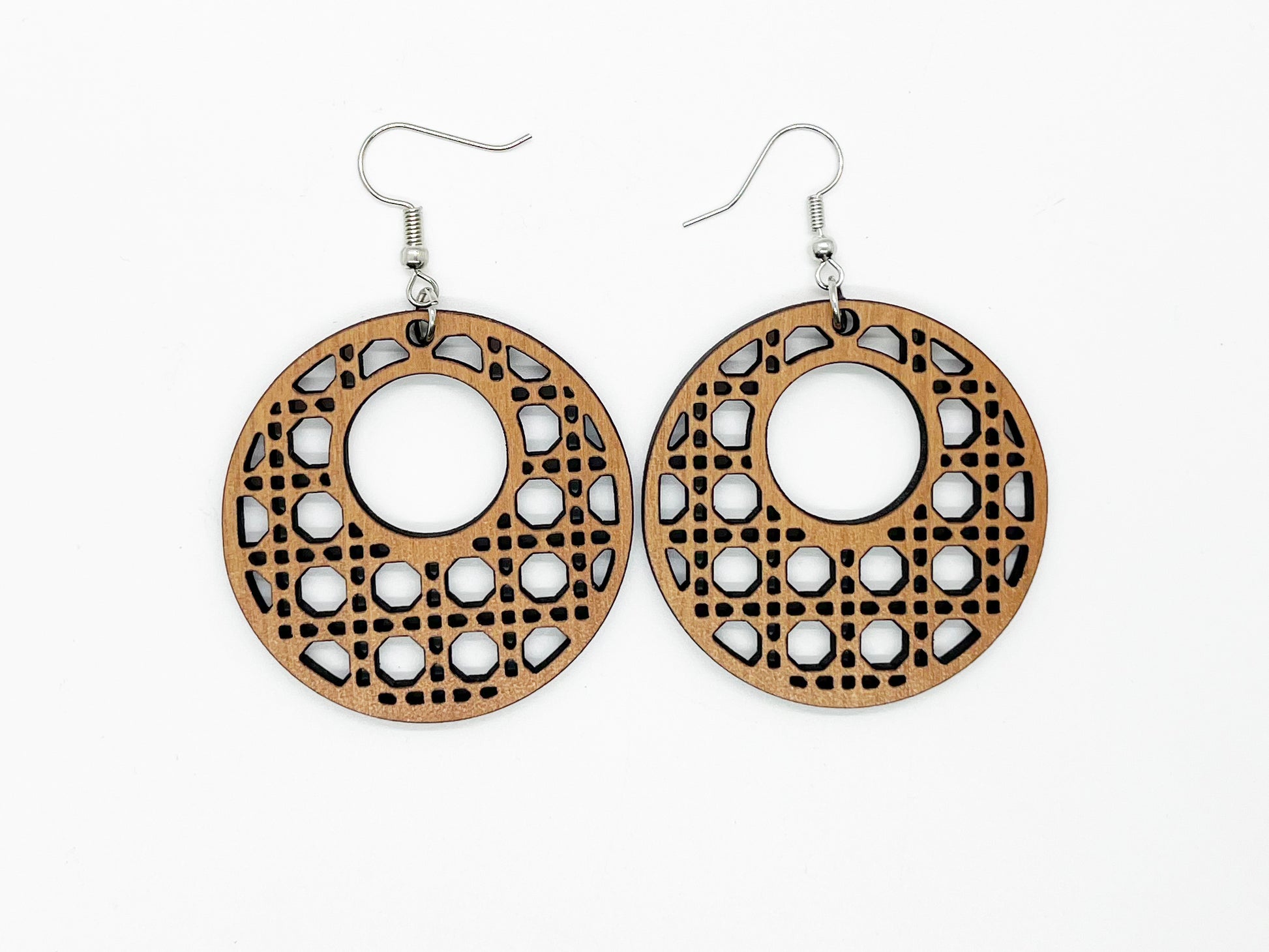 a pair of wooden earrings on a white background