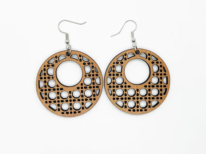 a pair of wooden earrings on a white background
