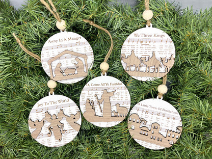 three wooden ornaments hanging from a christmas tree