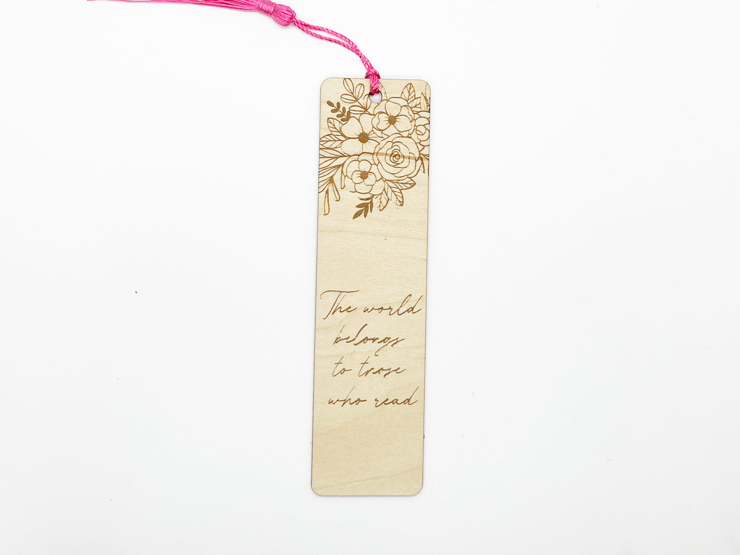 a wooden bookmark with a pink string attached to it