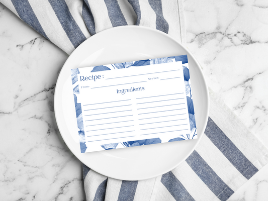 a white plate topped with a blue and white striped napkin