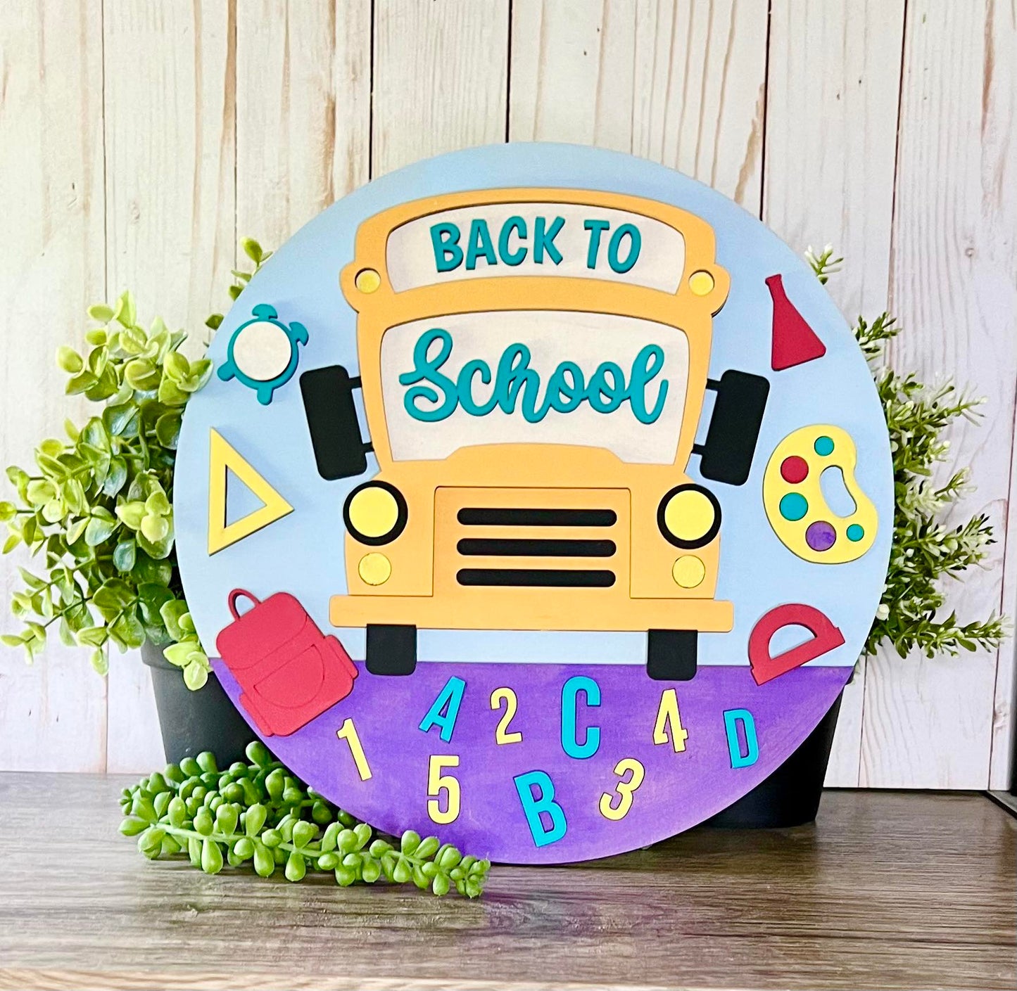 a back to school sign sitting on top of a wooden table