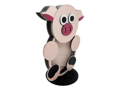 a paper cut out of a pig sitting on top of a table