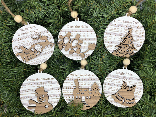 a group of wooden ornaments hanging from a christmas tree